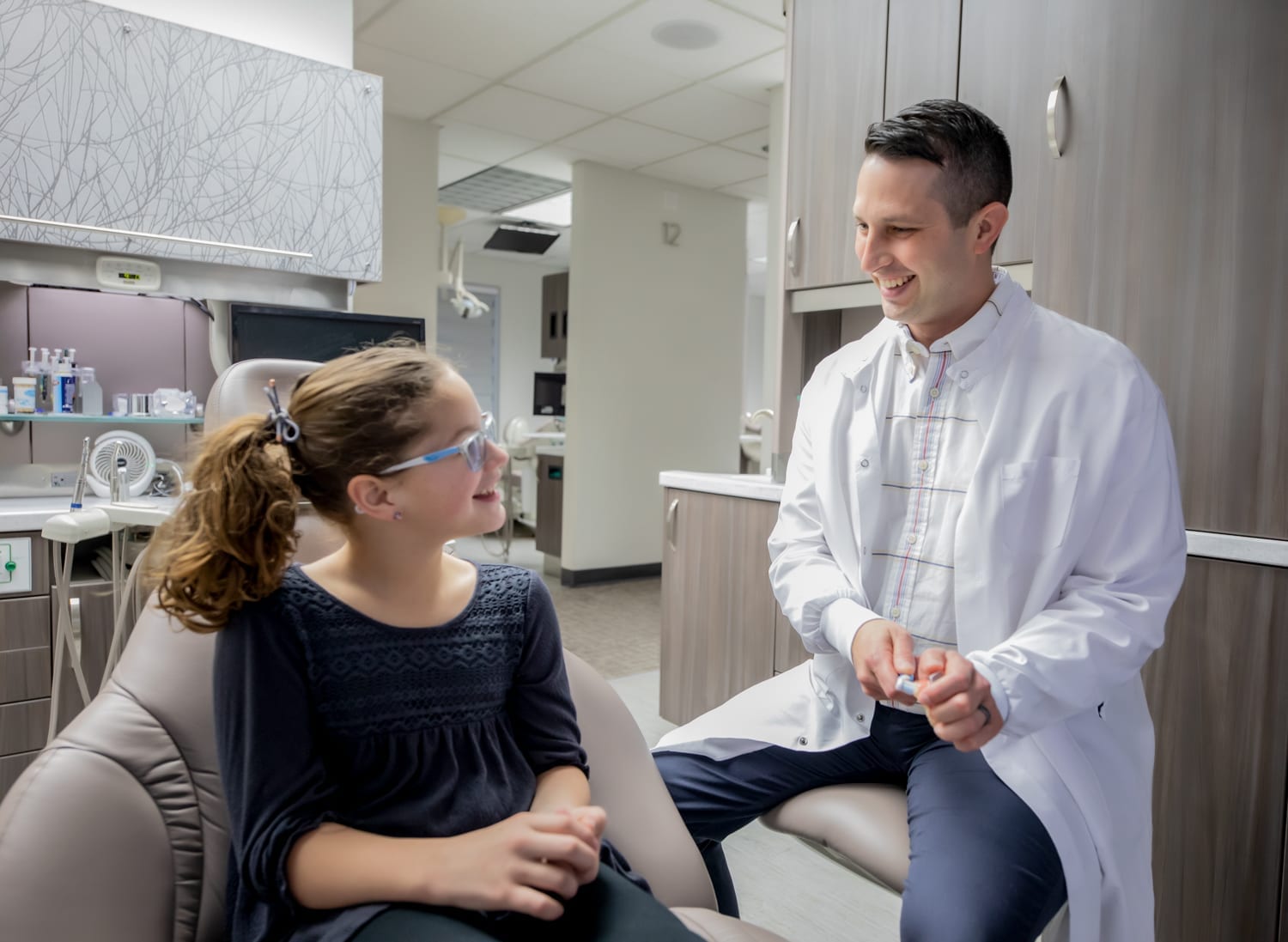 Dr. Karlson demonstrating a toothbrush at West Richland Family Dental for a female patient