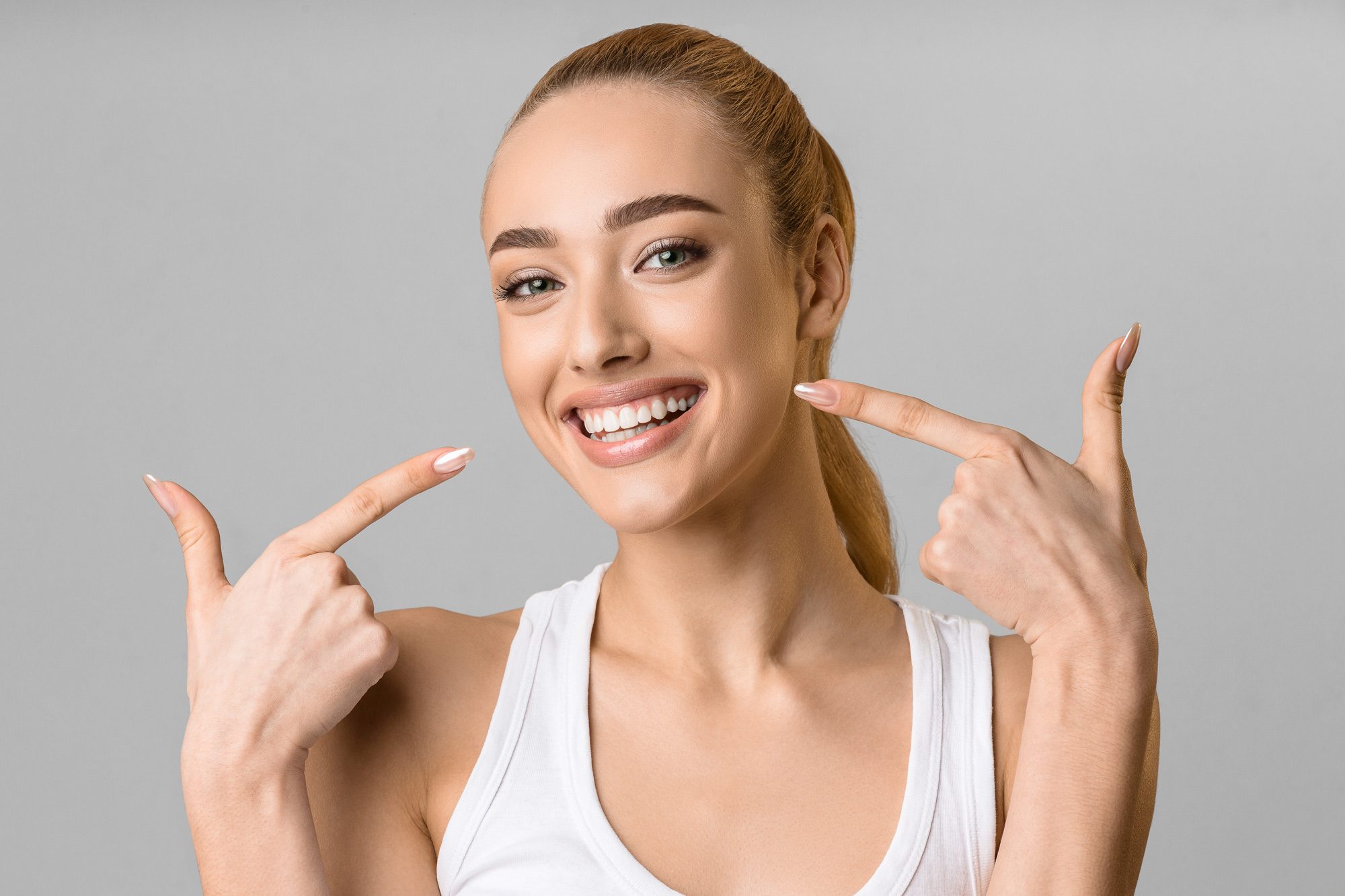 woman smiling after getting composite veneers from west richland family dental